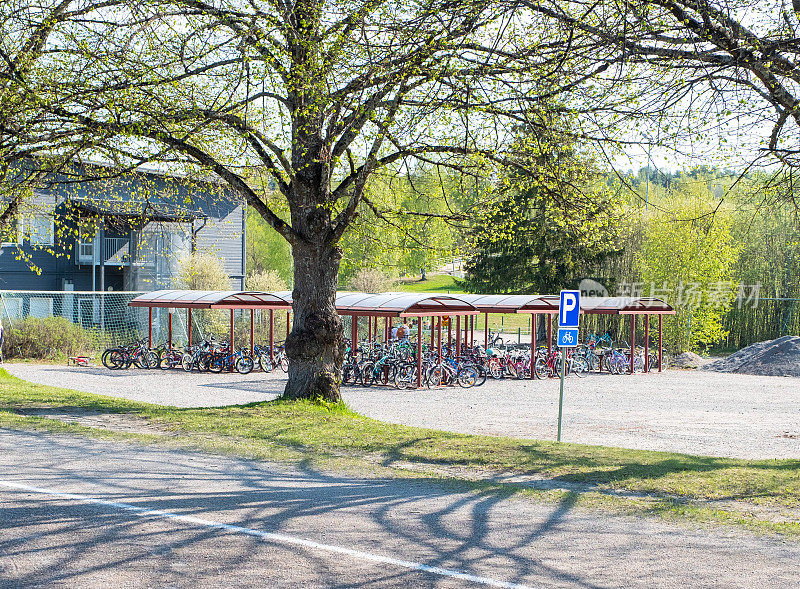 Bicycle parking for schoolchildren in a schoolyard in Lahti, Finland. Summer time of the year.